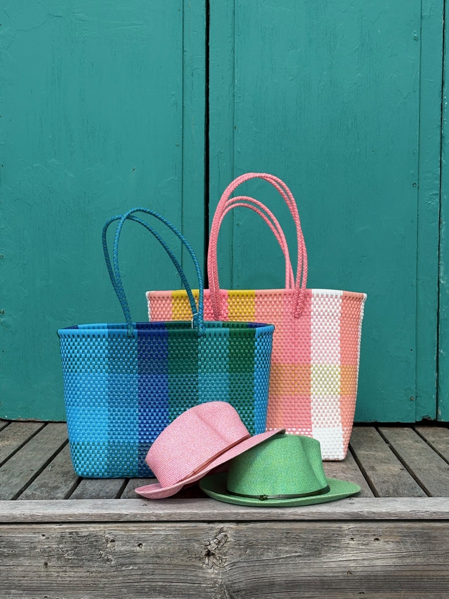 BAHIA woven baskets made from recycled plastic in blue, pink and multicolour, styled with Travaux en Cours summer hats