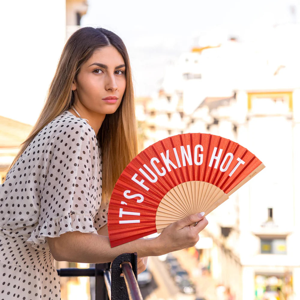 Fun Fisura hand fan shown open with printed design "it's fucking hot" in Red