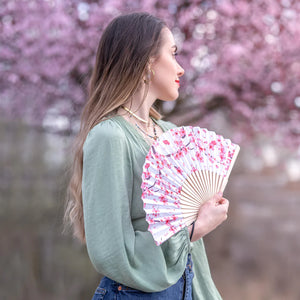 Fisura hand fan shown open with printed Japanese inspired design "Sakura"