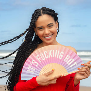 Fun Fisura hand fan shown open with printed design "it's fucking hot".