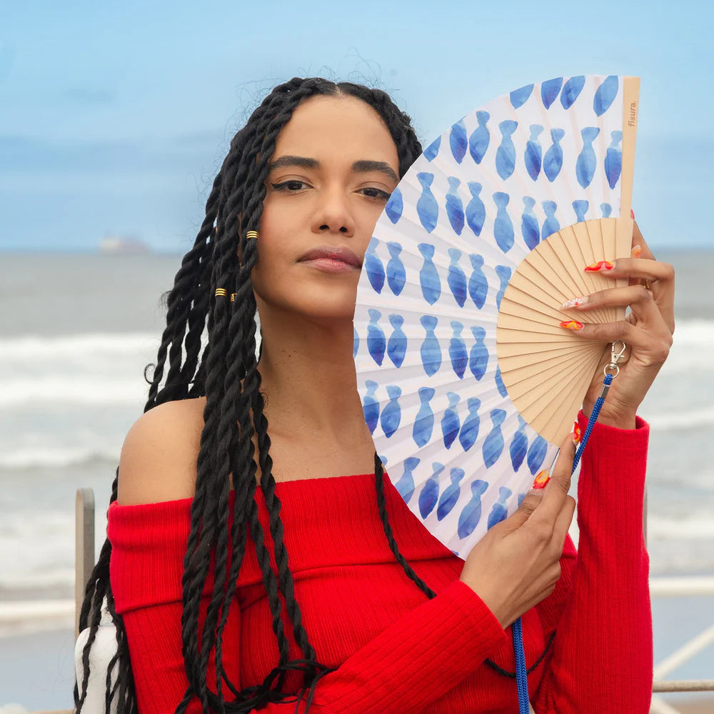 Fisura hand fan shown open with printed design "Fishes"