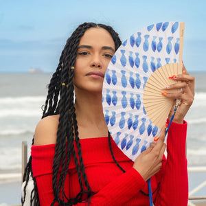 Fisura hand fan shown open with printed design "Fishes"