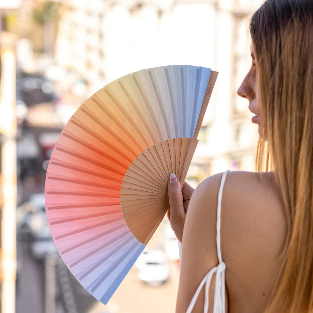 Fisura hand fan shown open with printed design "Gradiant Blue"