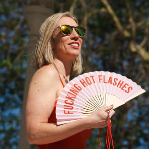 Fun Fisura hand fan shown open with printed design "Fucking Hot Flashes".