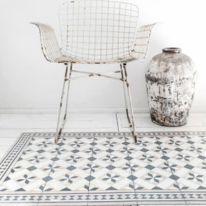 Beija Flor vinyl rug 'Gothic Powder' laid on the floor in an entryway setting.
