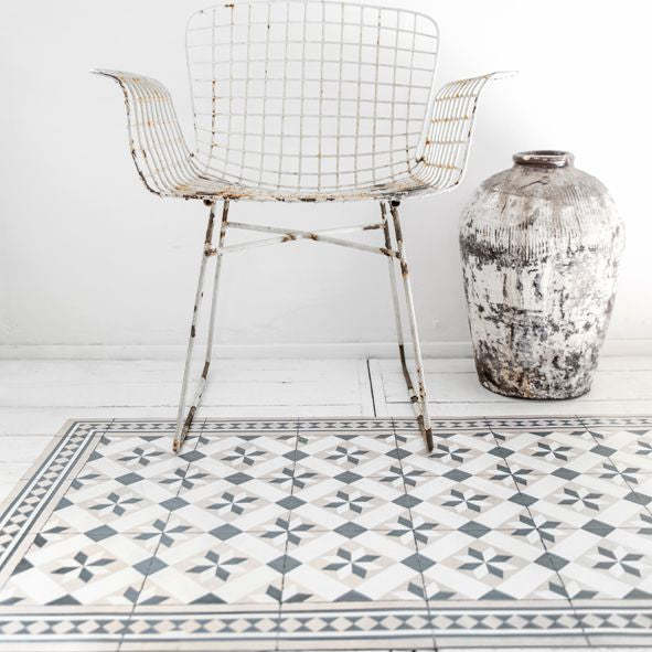 Beija Flor vinyl rug 'Gothic Powder' laid on the floor in an entryway setting.
