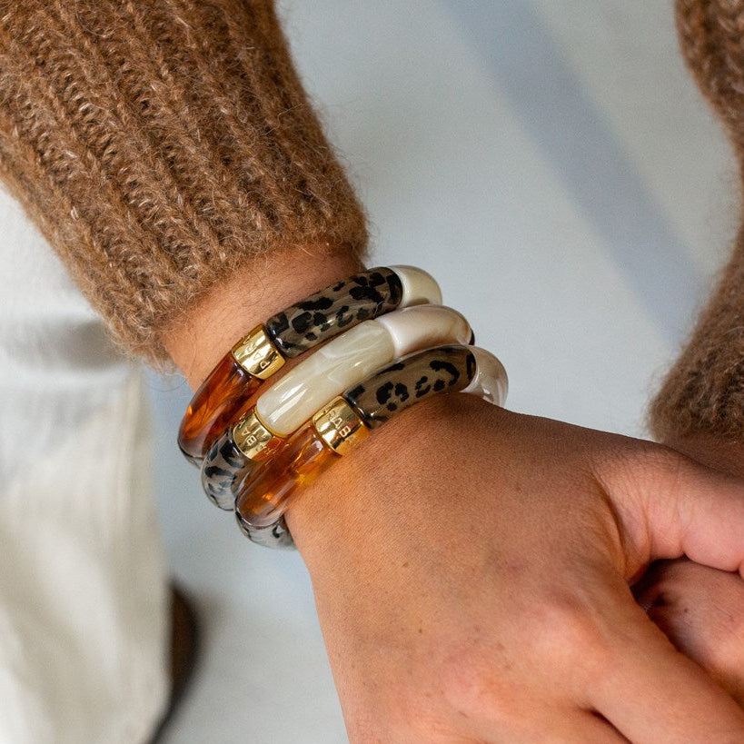 Parabaya Feli resin bangle bracelets set in hazelnut, cream and leopard tones worn on wrist