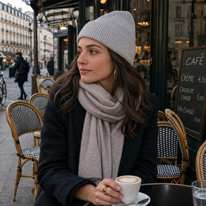 Woman wearing light grey knit beanie and scarf outdoors in Paris