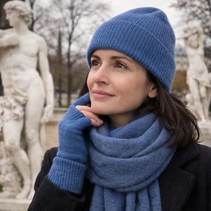 Woman wearing blue knit beanie and scarf outdoors in Paris