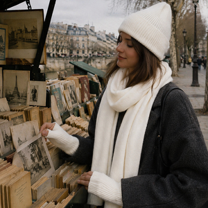 Woman wearing cream knit beanie and scarf outdoors in Paris