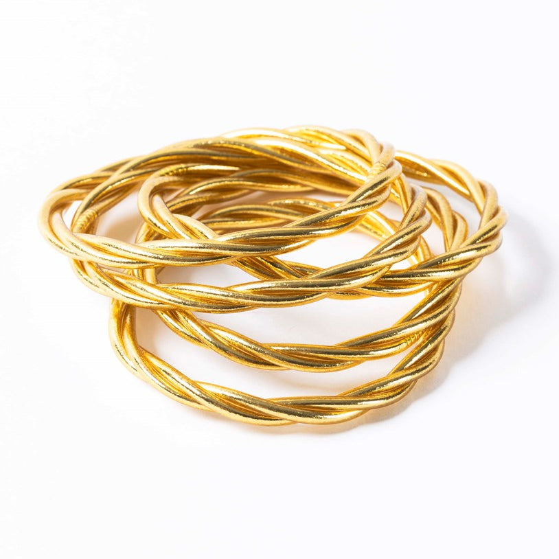 Twisted light gold Buddhist bangles, a symbol of good luck and prosperity