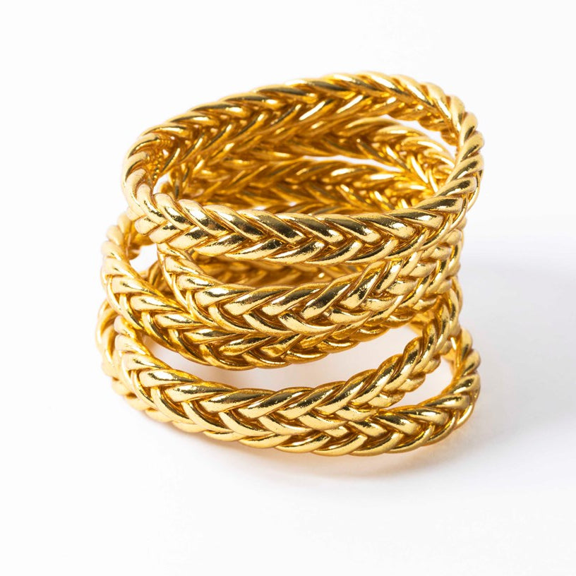 Light gold braided Buddhist bangles stacked together, flexible waterproof bracelets with gold leaf