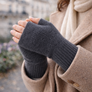 Woman wearing fingerless knit mittens in dark grey
