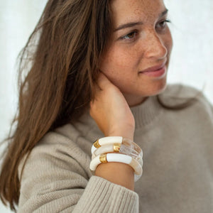 Parabaya cream resin bangle set worn on wrist, featuring soft white & neutral tones and gold-plated details