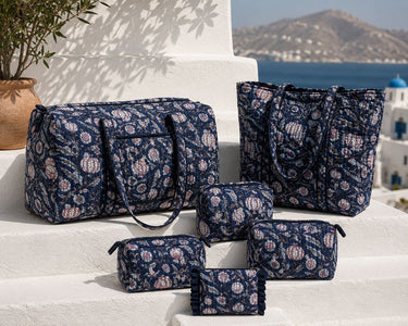 VOYAGE Carla navy floral set of 3 pouches with matching weekender and tote on a sunny Mediterranean terrace