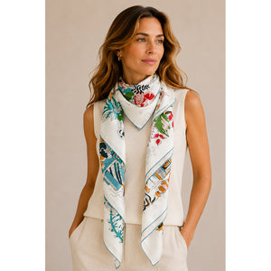 Woman wearing the MAISON FANLI Romantic Escapade Turquoise cotton and silk scarf 140x140cm with illustrated print