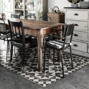 BEIJA FLOR Vinyl Rug- Gothic Concrete Black and white under a dining table