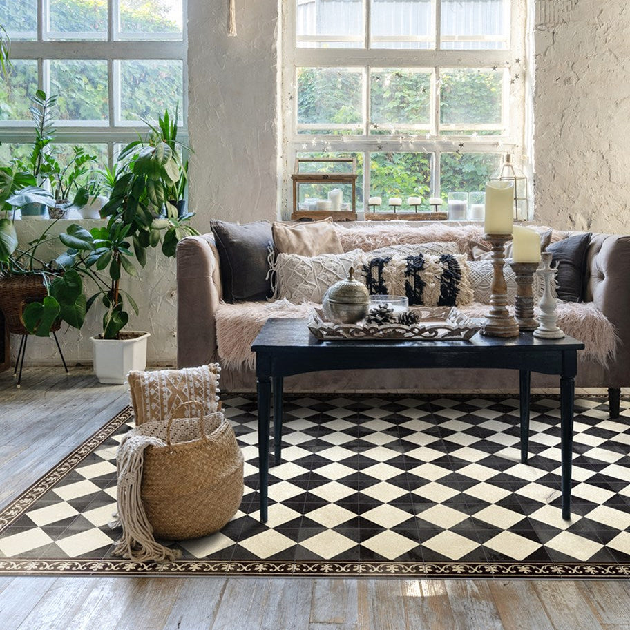 Beija Flor vinyl rug 'Gambit Chess Black&White' on a wooden floor in a warm, natural interior.
